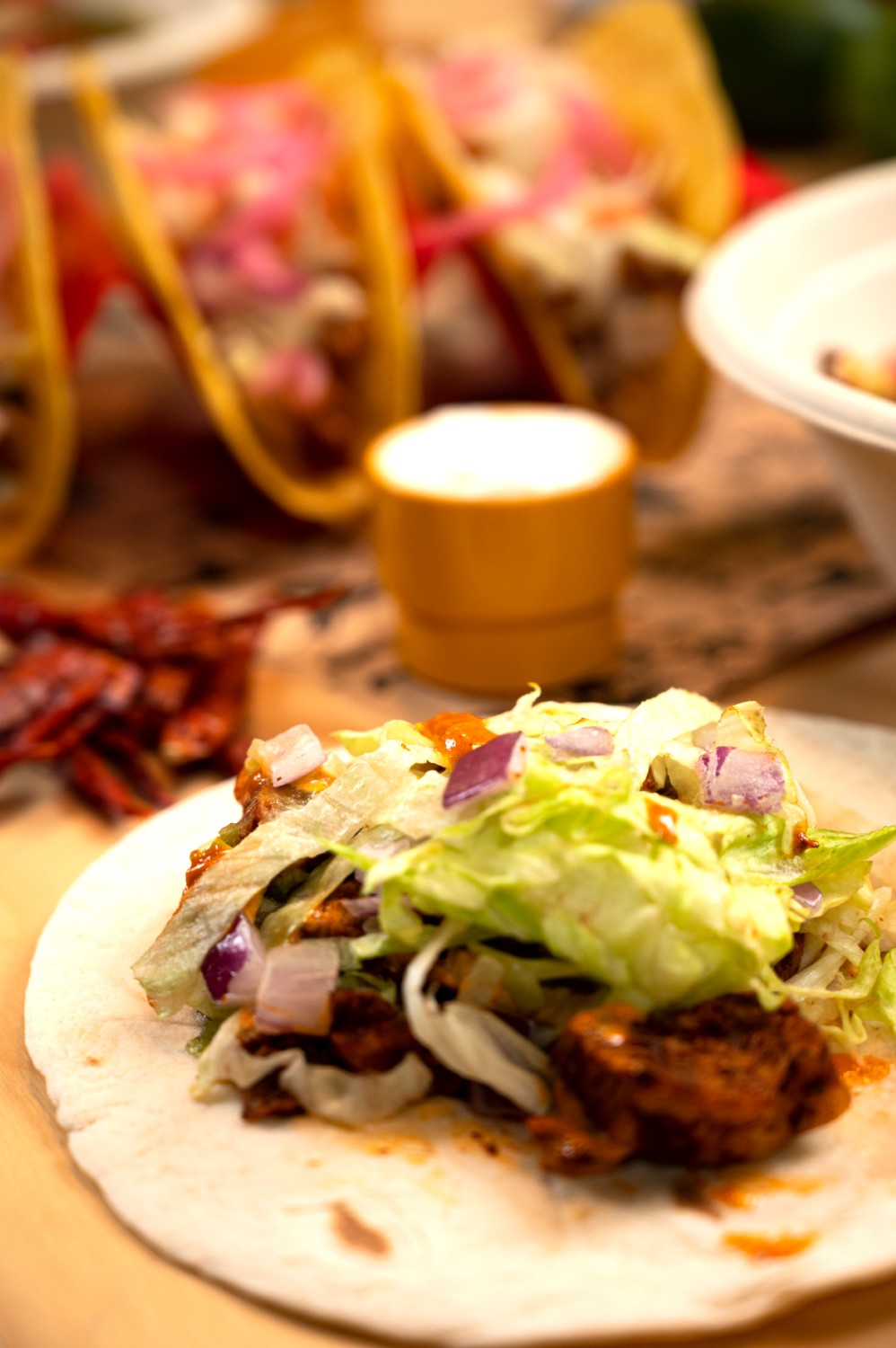 A burrito cut open on a striped serviette.