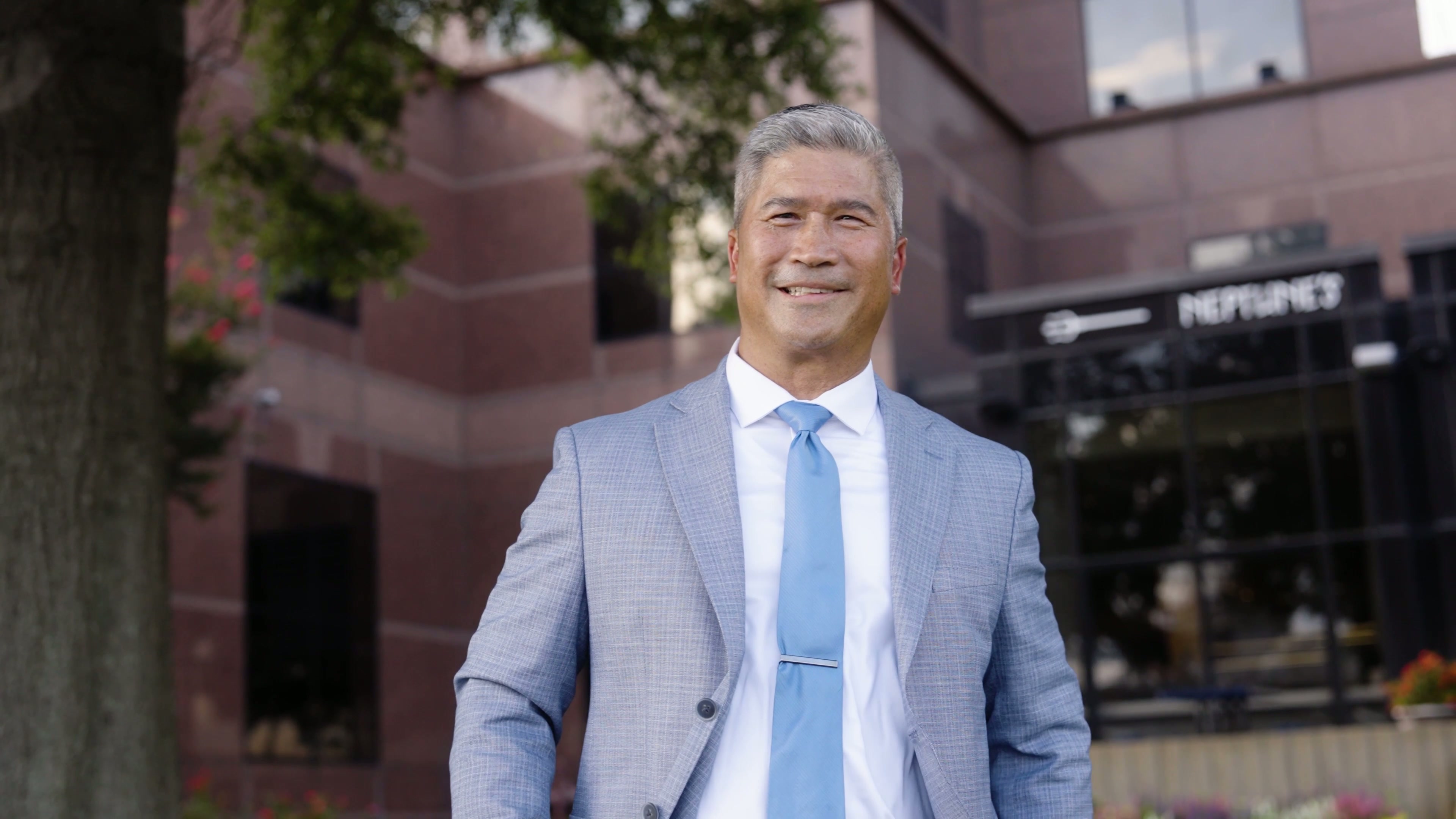 [CONFIRM] Dr Walt Whitley smiling outside the practice.